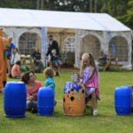 children playing with recycled drum cans